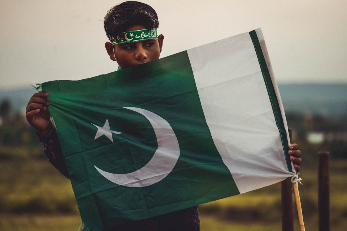 a young man holding a flag in his hands