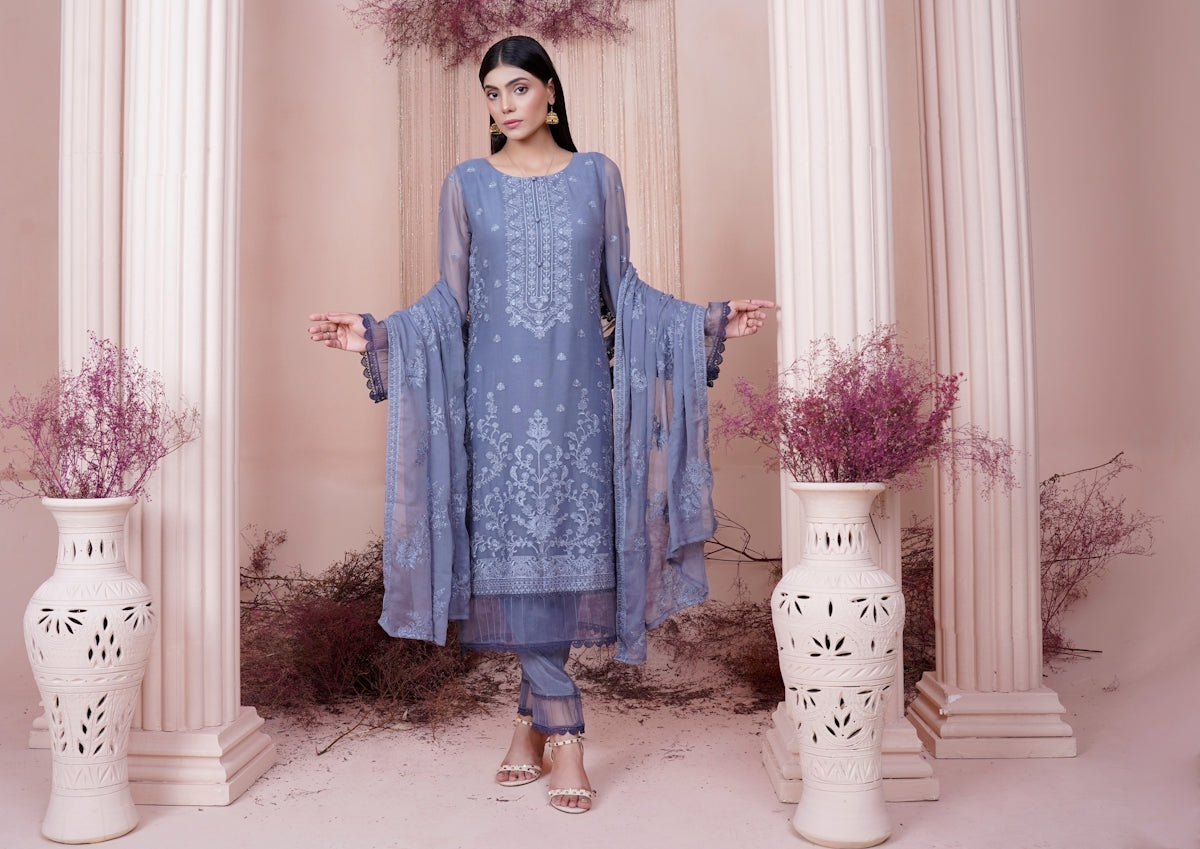 a woman in a blue dress standing in a room