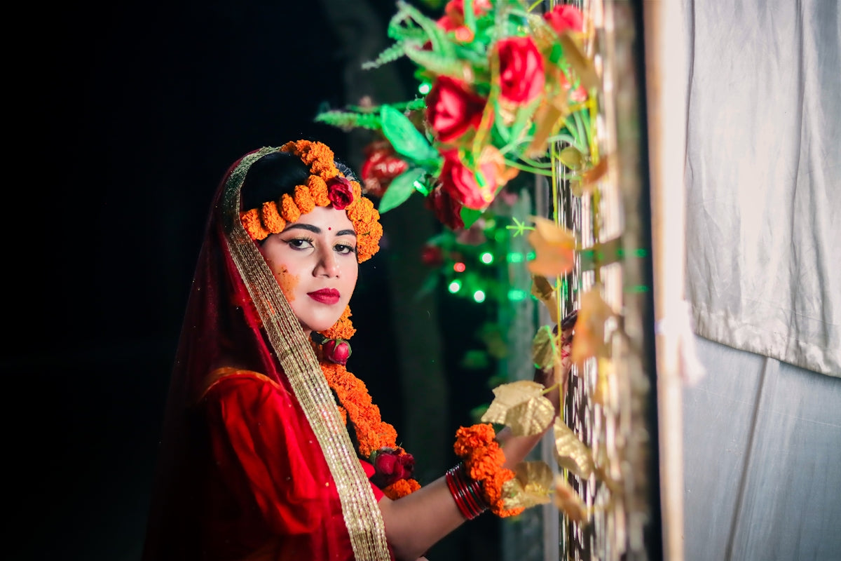A woman in traditional attire with floral adornments.