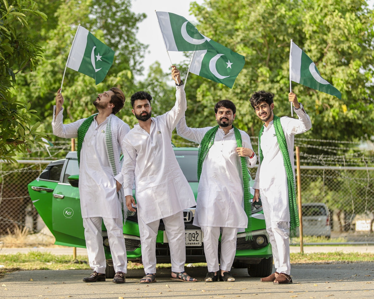 man in white karate gi holding green flag