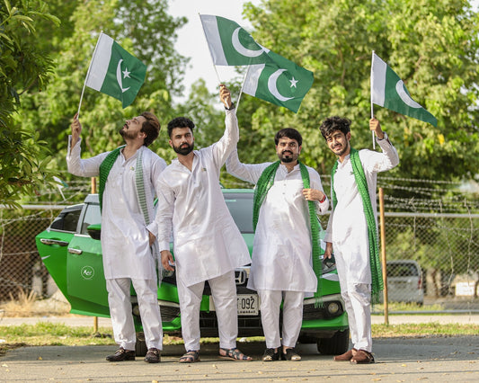 man in white karate gi holding green flag