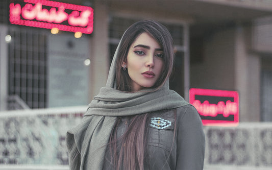 a woman with long hair wearing a scarf