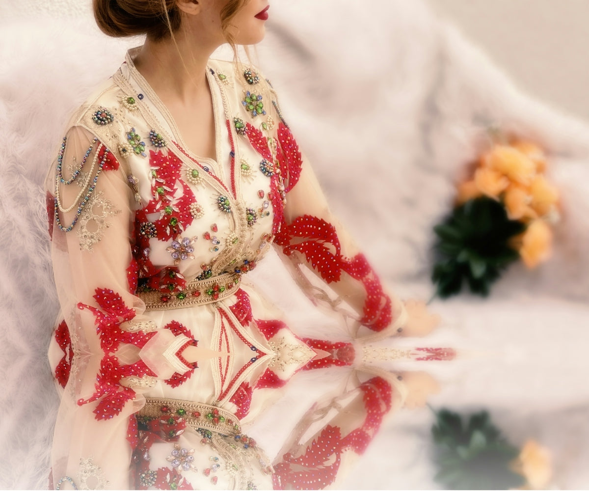a woman in a red and white dress sitting down
