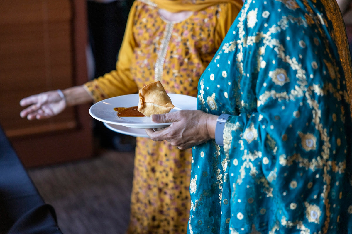 a person holding a plate of food