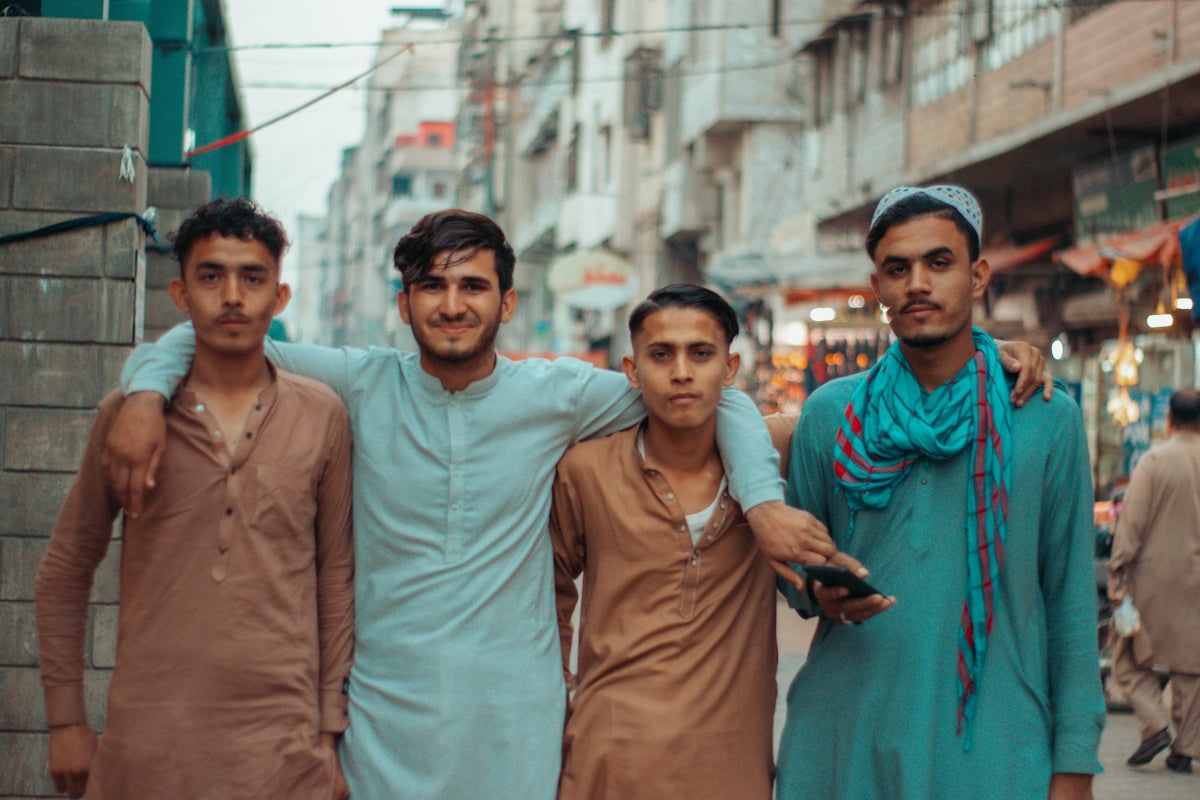 a group of men standing next to each other on a street