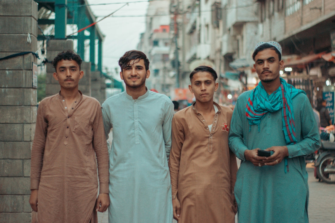 a group of men standing next to each other on a street