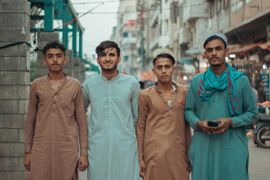 a group of men standing next to each other on a street