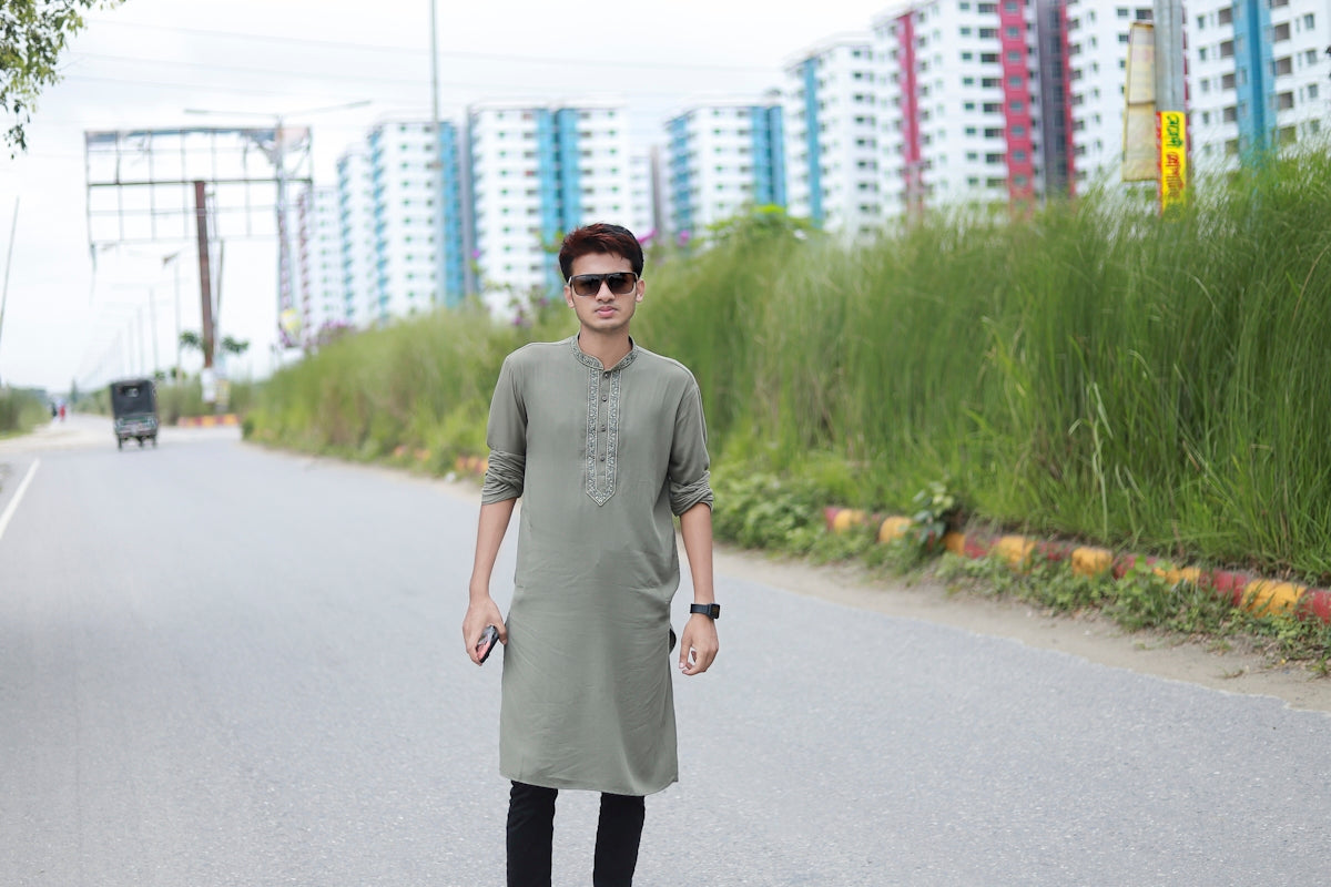 a man standing on the side of a road
