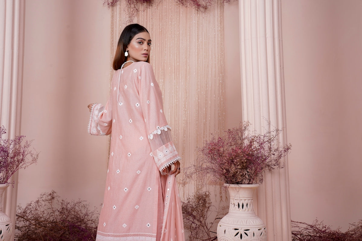 a woman in a pink outfit standing in a room