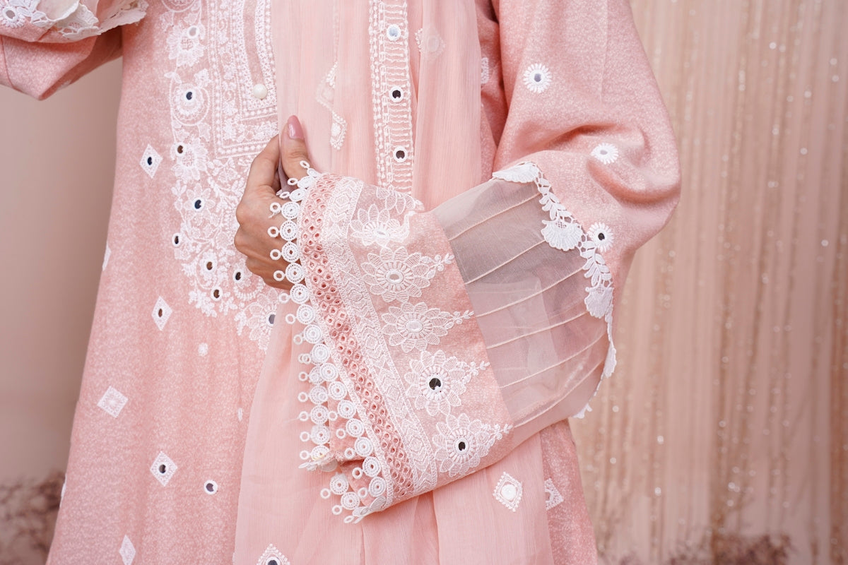 a close up of a person wearing a pink dress