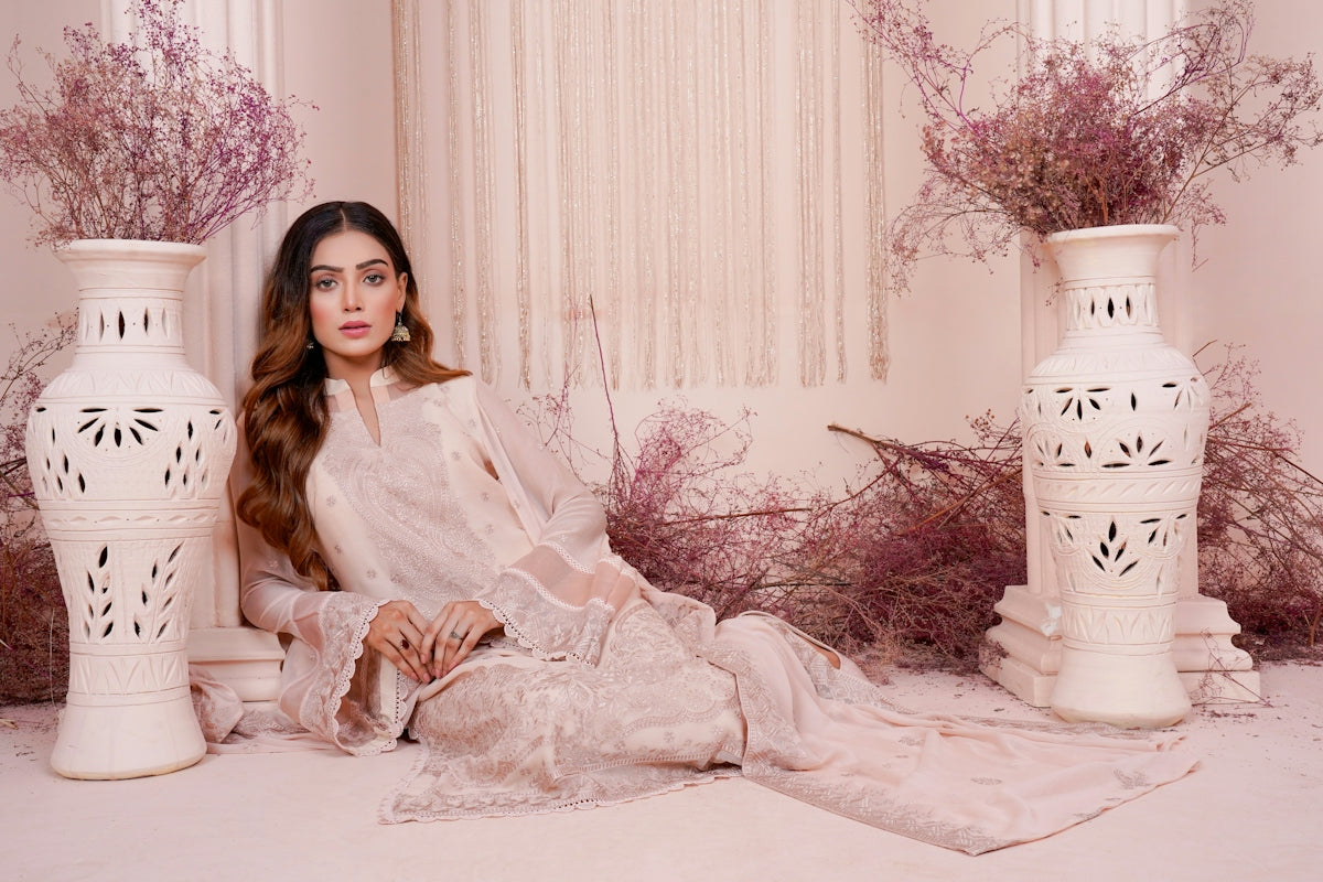 a woman sitting on a floor next to two vases