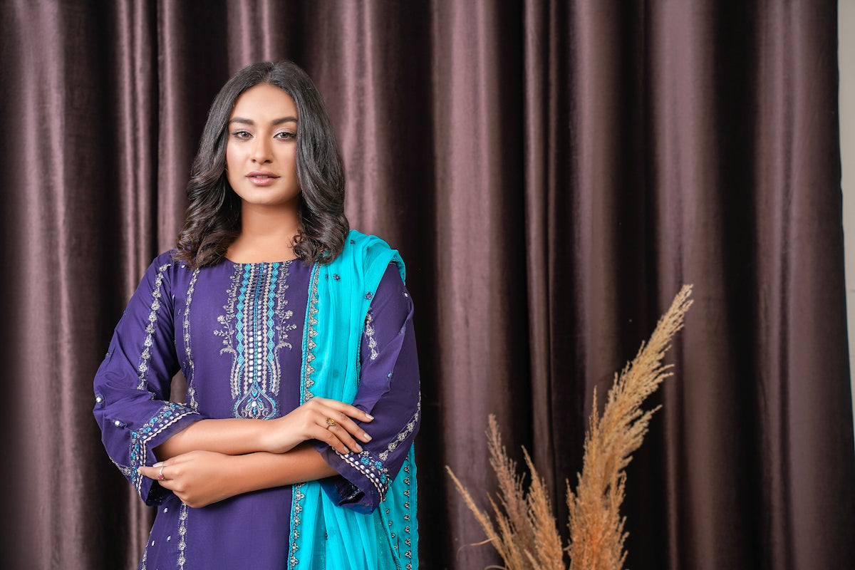 a woman standing in front of a curtain