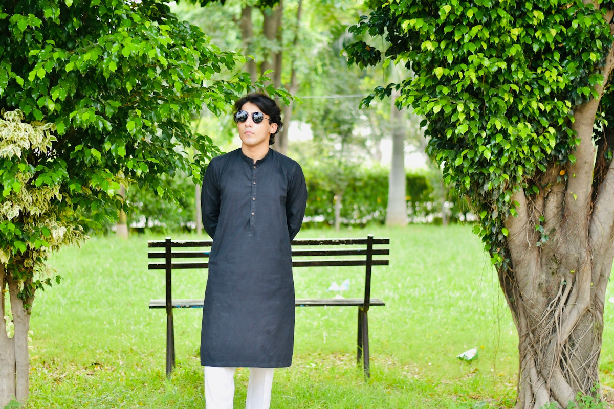 a man standing in front of a park bench