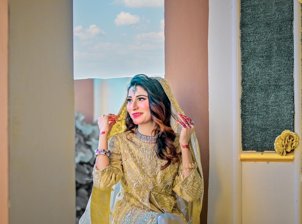 A woman in a yellow outfit standing in front of a window