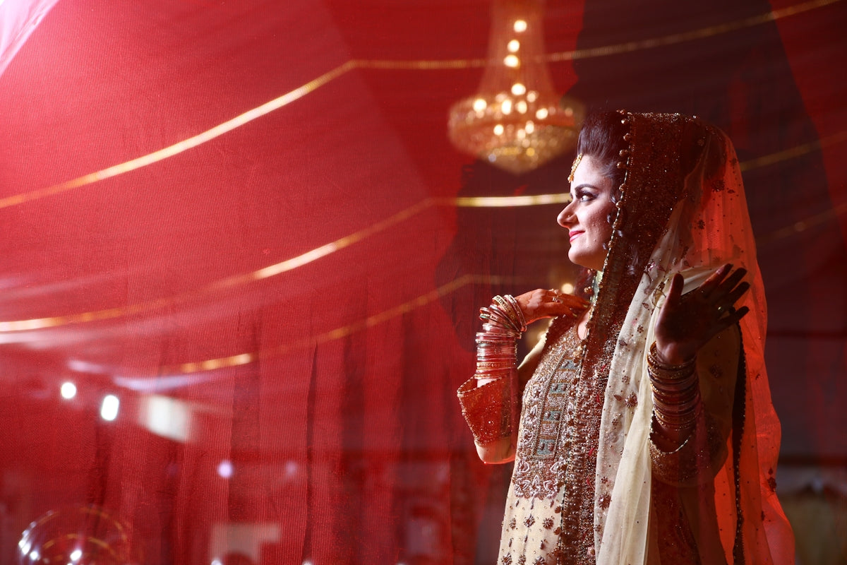 A woman in a bridal gown standing in a room