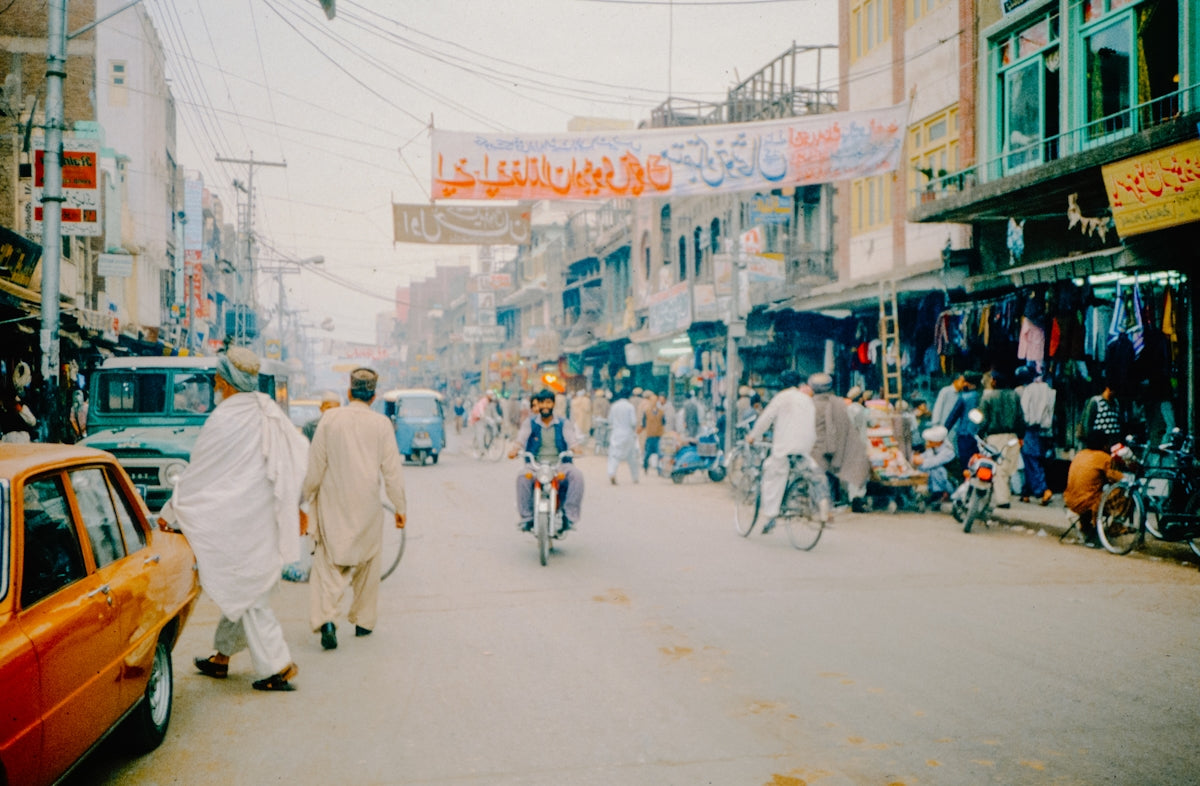 A group of people riding bikes down a street